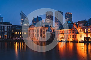 The Hague\'s Binnenhof with the Hofvijver lake and modern buildings at dusk, Den Haag, Netherlands