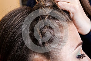 Haidresser braiding hair