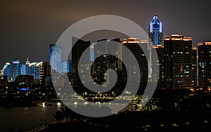 Haikou city skyline with sea and shoreline illuminated at night Haikou Hainan China