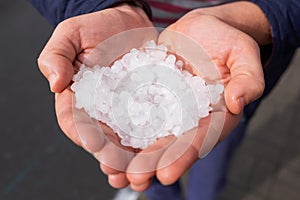 Hail in caucasian woman hands after hailstorm