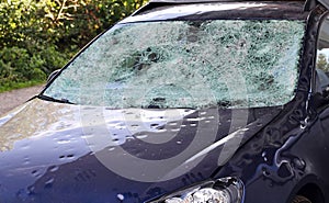 Hail damage to a car. Large hailstones have completely destroyed a car