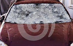 Hail damage to a car. Large hailstones have completely destroyed a car