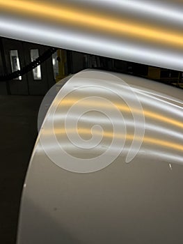 A hail dent on a hood of a vehicle.