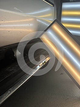 Hail dent on a running board on a truck being repaired with glue pulling process