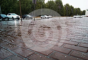 Hail in the street and parking, the floor is covered with icy hail