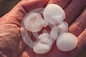 Hailstones the size of golf balls in a hand after severe storm