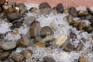 Hailstones spread on the ground with decorative stones.