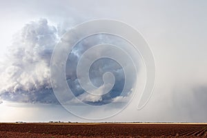 Hailstorm over a farm field photo