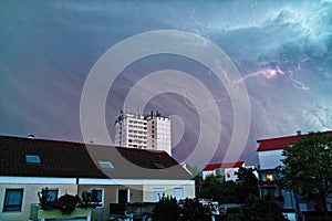 Hailstorm and lightning over residential area photo