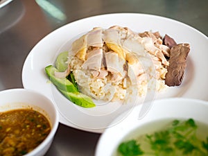 Hainanese chicken rice on a plate with soup