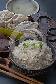 Hainanese chicken rice (Steamed chicken with rice) is sprinkled with Coriander and Pork blood puddings.