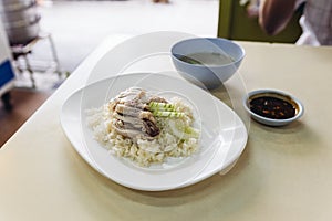 Hainanese chicken rice, Thai gourmet steamed chicken with rice served with sliced of cucumber and soup