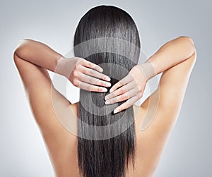 Hair, back and woman hands in studio with wellness, cosmetics and shampoo treatment, shine or results on white
