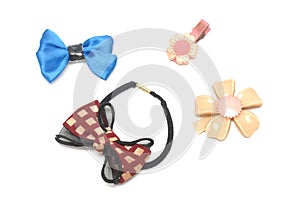 A hair band and some hair clips of flowery and ribbon designs