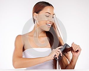 Hair, beauty and woman in studio for comb, brushing and styling against a white background mockup. Hair care, wellness