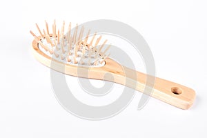 Hair brush made from wood, white background.
