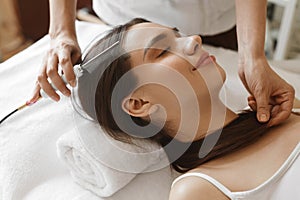 Hair Care. Beautiful Woman Receiving Brushing Beauty Treatment