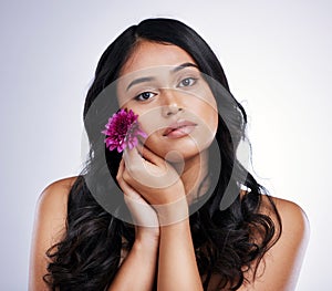 Hair care, beauty and portrait of woman with flower, natural makeup and luxury salon treatment on white background