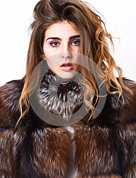 Hair care concept. Girl fur coat posing with hairstyle on white background close up. Prevent winter hair damage. Woman