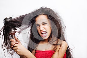 Hair care concept with portrait of girl brushing her hair