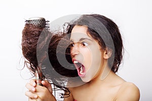 Hair care concept with portrait of girl brushing her hair