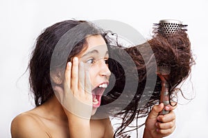 Hair care concept with portrait of girl brushing her hair