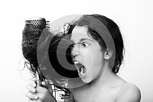 Hair care concept with portrait of girl brushing her unruly, tangled long hair