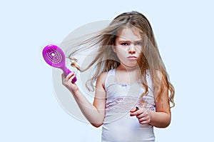 Hair care concept with portrait of girl brushing her unruly, tangled long hair