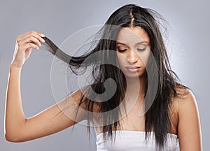 Hair care, damage and face of woman in studio with worry for split end, haircare crisis and weak strand. Beauty