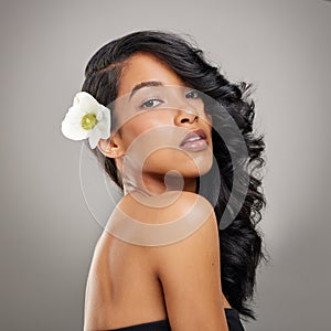 Hair care, flower and portrait of woman in studio with beauty, health and salon treatment for confident. Natural