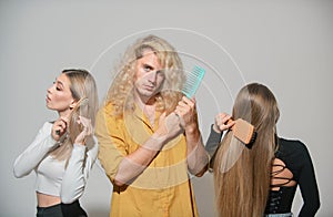Hair Care. Group Hairbrushing Hair With Brush. Portrait Woman and Man Brushing Long Healthy Hair With Hairbrush. Womens