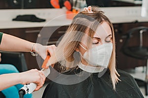 Hair care, hairdresser cuts the cut ends of hair and straightens the length, the work of hairdressers during the global