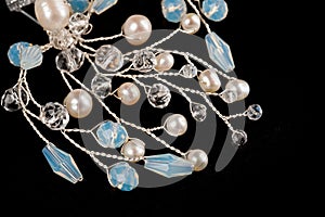 A hair clip on a hairpin in the form of a twig made of silver wire, decorated with river pearls and crystal