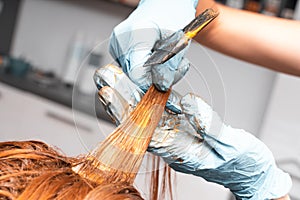 Hair Coloring In A Beauty Salon. Professional wizard paints the hair in the salon. Beauty concept, hair care