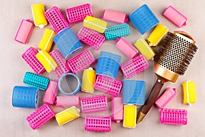 Hair curlers of different colors and the comb top view