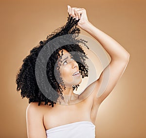 Hair, curly and stress with woman in studio, damage or dry with treatment regret and wellness on brown background