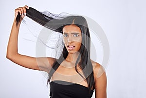 Hair damage, breakage and portrait of a frustrated woman isolated on a white background in studio. Bad, unhappy and an