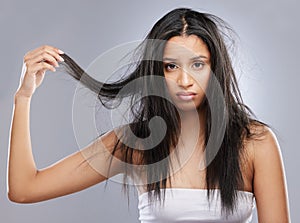 Hair, damage and portrait of woman in studio with worry for split ends, haircare crisis and weak strand. Beauty