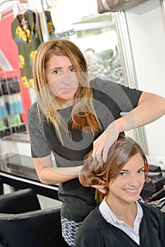 Hair dresser brushing hair