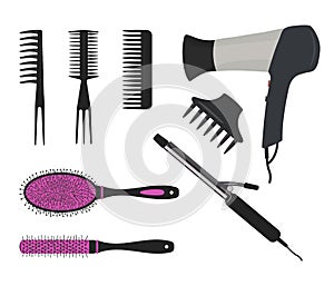 Hair dryer, a curling iron and different types of hair brushes on a white background