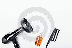 Hair dryer with diffuser nozzle, bottle of nourishing oil