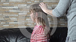 Hair drying process. Mom hands dries hair with hairdryer of cute beautiful blonde daughter.
