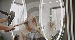 Hair drying of a woman in the hairstyling studio, trucking