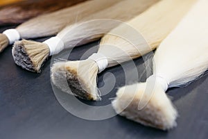 Hair extensions of five colors on a dark background. copyspace. top view.