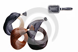 Hair extensions of three colors on a white background with comb. copyspace top view.