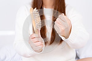 Hair fall problem, closeup hand holding comb and problem hair. Healthcare medical or daily life concept