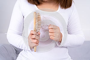 Hair fall problem, closeup hand holding comb and problem hair. Healthcare medical or daily life concept