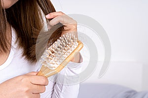 Hair fall problem, closeup hand holding comb and problem hair. Healthcare medical or daily life concept