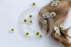 Hair with flowers. Closeup, selective focus.