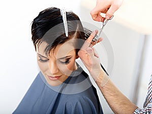 Hair. Hairdresser Cutting Woman Hair in Beauty Salon. Haircut